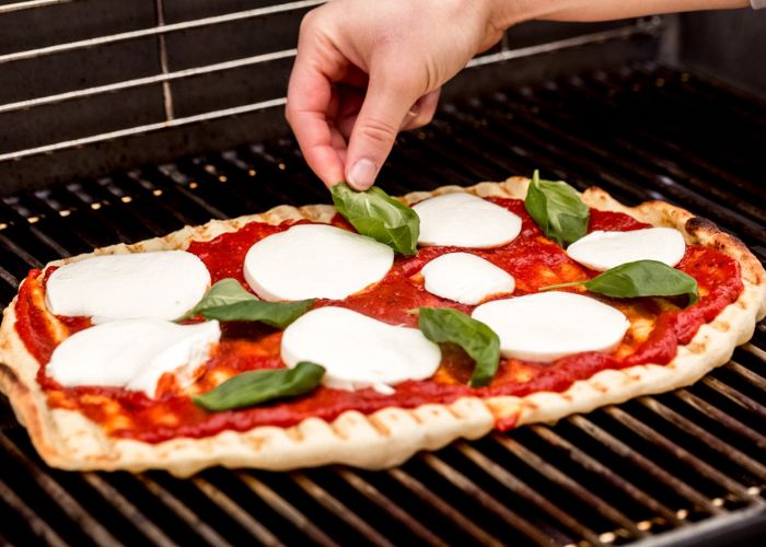 What are some tips for grilling the perfect pizza?